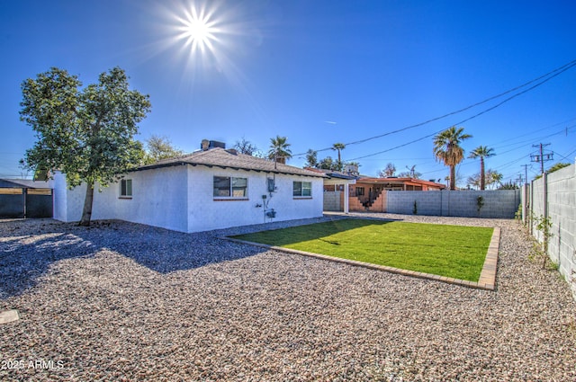 rear view of house with a yard