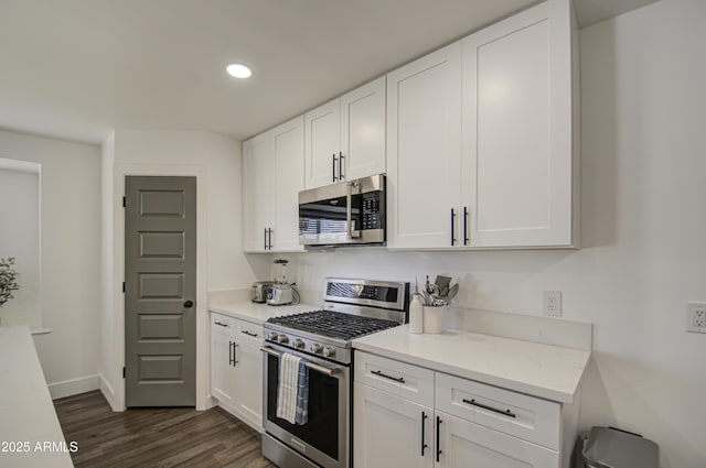 kitchen with white cabinetry, light stone countertops, and appliances with stainless steel finishes