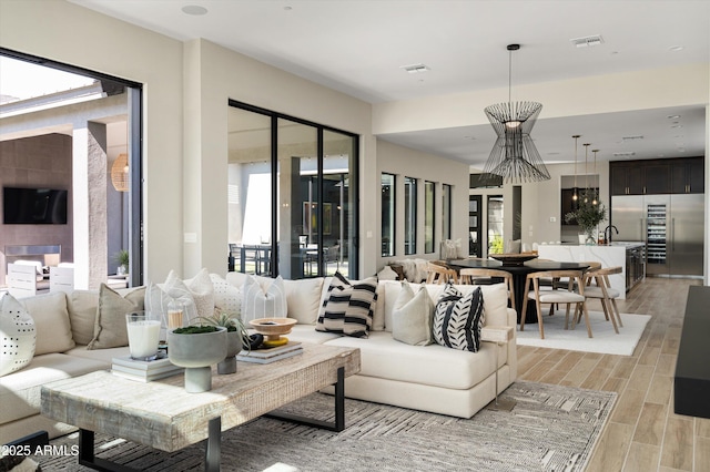 living room featuring visible vents and wood tiled floor