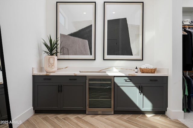 bar featuring wine cooler and baseboards