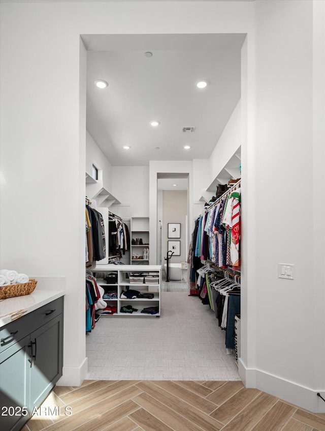 walk in closet featuring wood tiled floor and visible vents