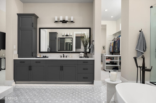 full bath featuring a freestanding bath and vanity