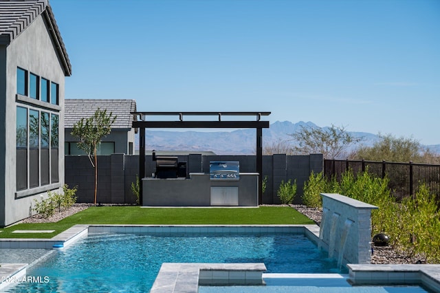 view of pool with a fenced backyard, a mountain view, a grill, a pool with connected hot tub, and a lawn