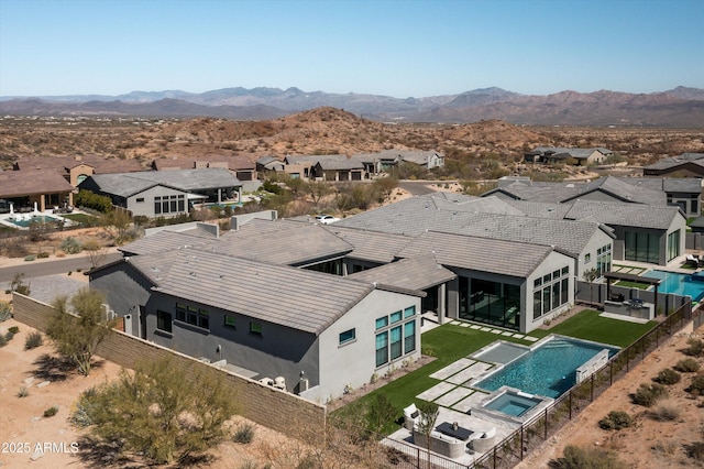 drone / aerial view with a residential view and a mountain view