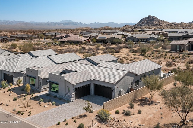 drone / aerial view featuring a residential view and a mountain view