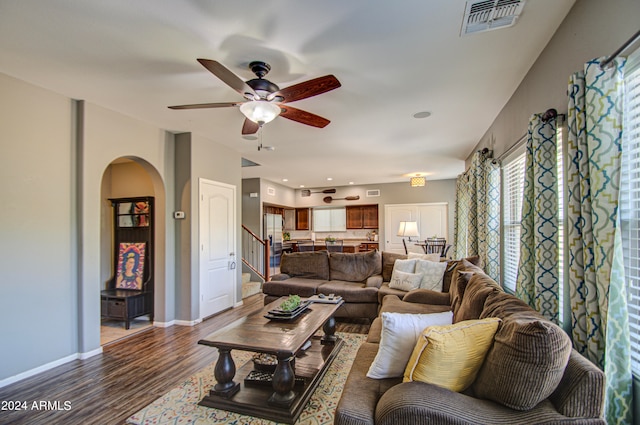 living room featuring hardwood / wood-style floors and ceiling fan