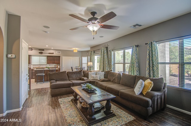 living room with dark hardwood / wood-style floors and ceiling fan