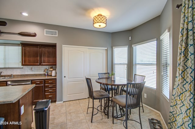 dining area with light tile patterned floors