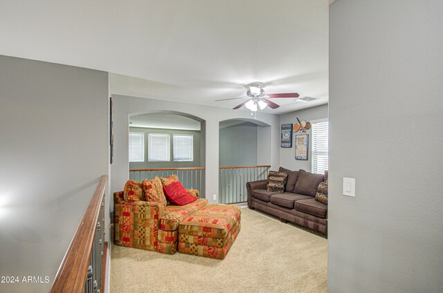 living room with light colored carpet and ceiling fan