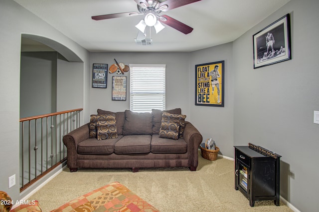 carpeted living room featuring ceiling fan