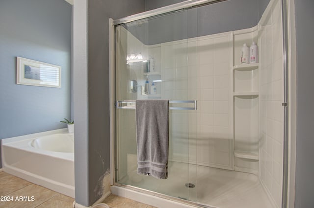 bathroom with tile patterned flooring and plus walk in shower