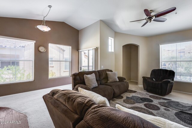 carpeted living room featuring ceiling fan, lofted ceiling, and a healthy amount of sunlight