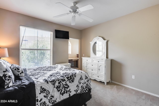 bedroom featuring baseboards, ceiling fan, and light colored carpet