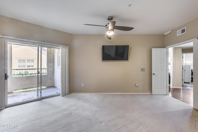 spare room featuring baseboards, carpet flooring, visible vents, and a ceiling fan