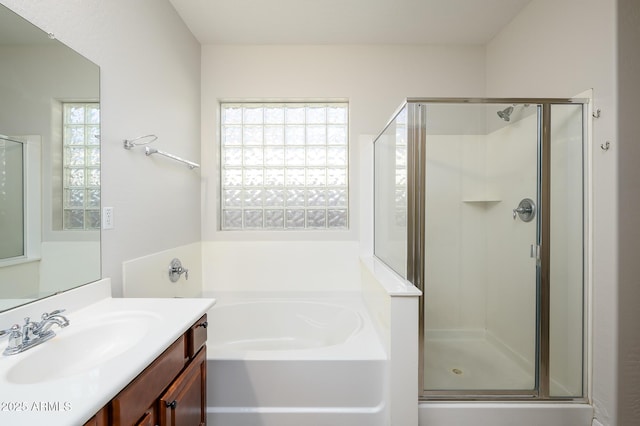 bathroom featuring separate shower and tub and vanity