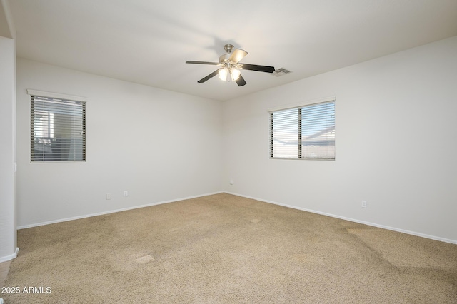 carpeted spare room with ceiling fan