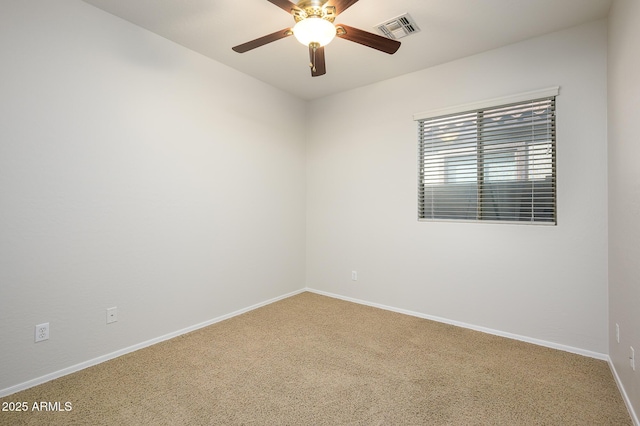 carpeted spare room with ceiling fan