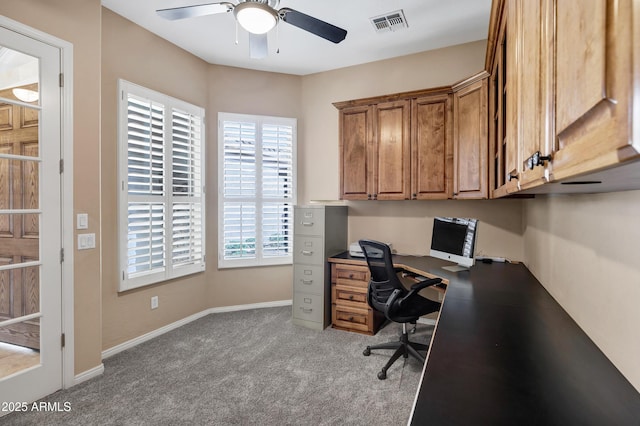 office area featuring carpet floors, visible vents, baseboards, and a ceiling fan