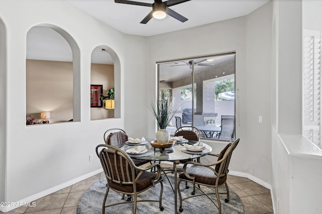 dining space featuring baseboards, ceiling fan, and tile patterned floors