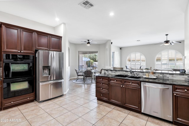 kitchen with light tile patterned floors, visible vents, appliances with stainless steel finishes, a ceiling fan, and a sink