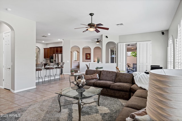 living area with recessed lighting, visible vents, baseboards, and light tile patterned floors