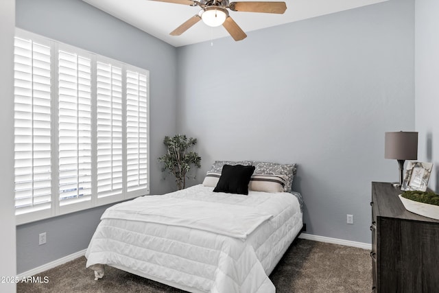 carpeted bedroom with ceiling fan and baseboards