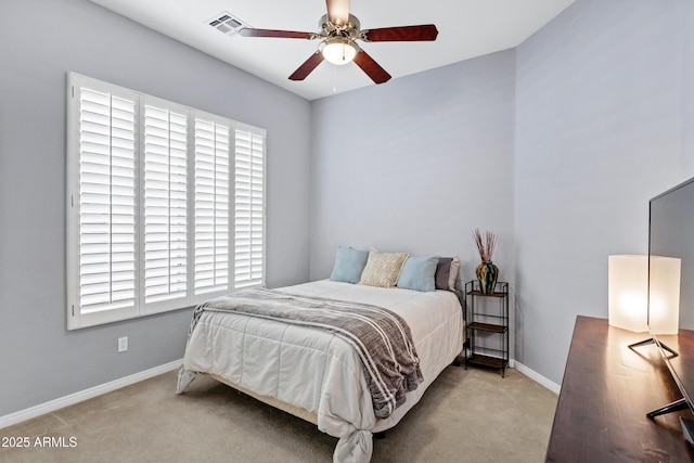 carpeted bedroom featuring ceiling fan, visible vents, and baseboards