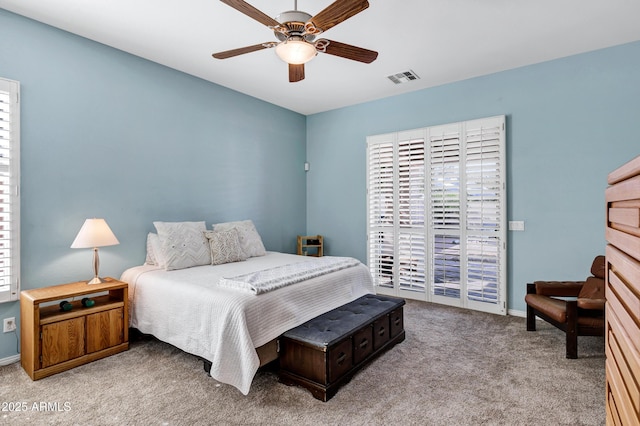 bedroom with ceiling fan, light carpet, visible vents, baseboards, and access to exterior