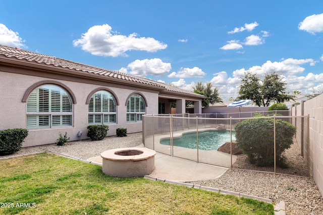 view of swimming pool with a fenced in pool, a lawn, an outdoor fire pit, a patio area, and a fenced backyard