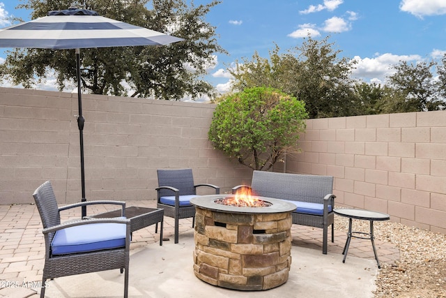 view of patio with an outdoor fire pit and a fenced backyard