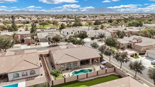 drone / aerial view featuring a residential view and a mountain view