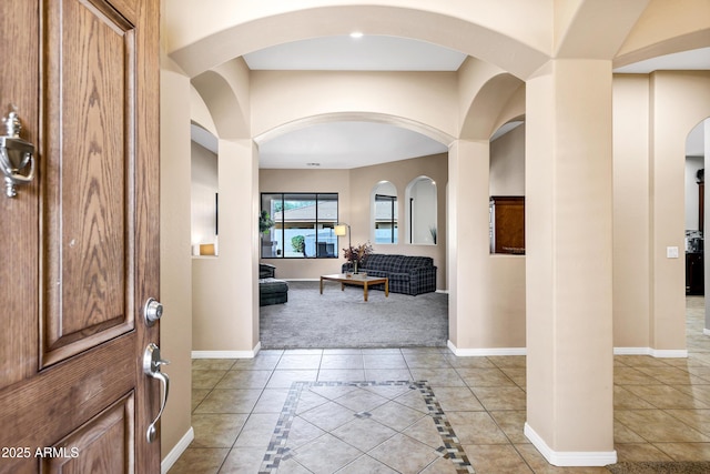 tiled entryway featuring baseboards