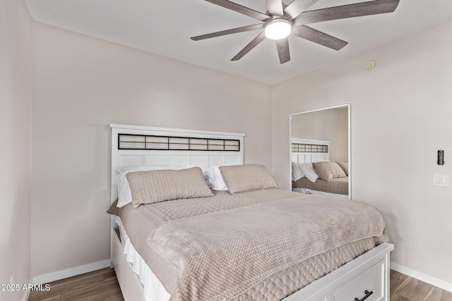 bedroom with ceiling fan and dark hardwood / wood-style floors