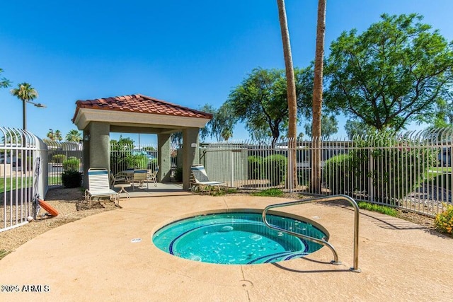 view of swimming pool with a hot tub and a patio area