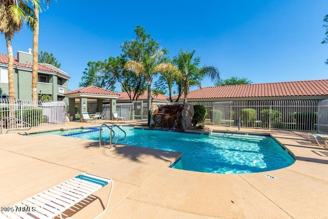 view of swimming pool with a gazebo, a patio area, and pool water feature