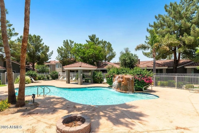 view of swimming pool featuring a gazebo, a patio area, and a fire pit