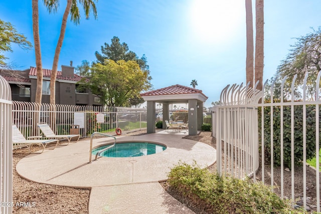 view of swimming pool featuring a gazebo, a community hot tub, and a patio area