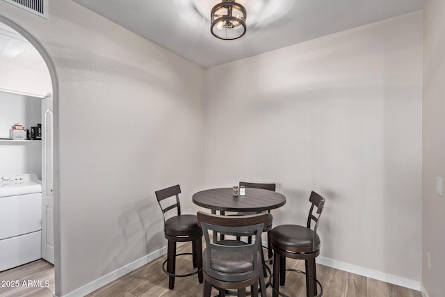 dining room with washer / clothes dryer and light hardwood / wood-style floors