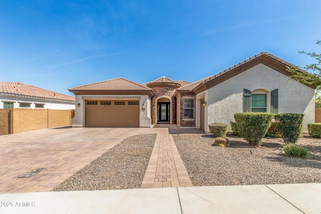 1342 E Milada Dr, Phoenix, AZ 85042 - view of front facade featuring stucco siding, a garage, driveway, and a tile roof
