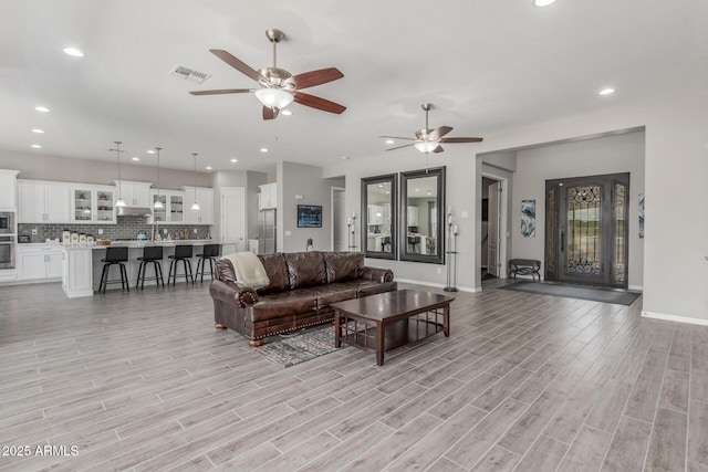 1342 E Milada Dr, Phoenix, AZ 85042 - living room with ceiling fan, light wood-type flooring, baseboards, and recessed lighting