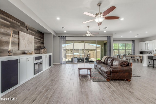 1342 E Milada Dr, Phoenix, AZ 85042 - living area featuring a ceiling fan, light wood finished floors, and recessed lighting