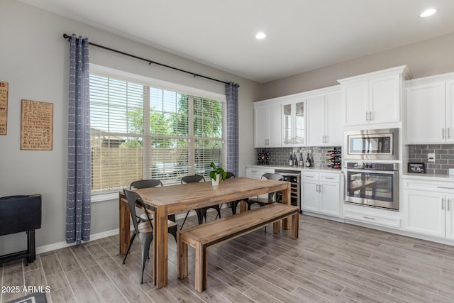 1342 E Milada Dr, Phoenix, AZ 85042 - dining room with light wood-type flooring, recessed lighting, beverage cooler, baseboards, and a dry bar