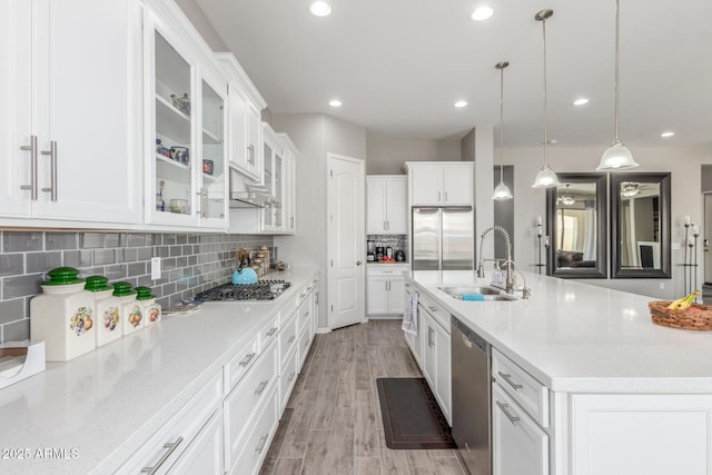 1342 E Milada Dr, Phoenix, AZ 85042 - kitchen featuring appliances with stainless steel finishes, a sink, white cabinetry, decorative backsplash, and light wood finished floors