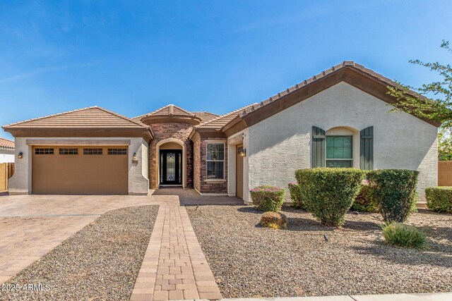 1342 E Milada Dr, Phoenix, AZ 85042 - view of front of house featuring stucco siding, an attached garage, driveway, and a tile roof