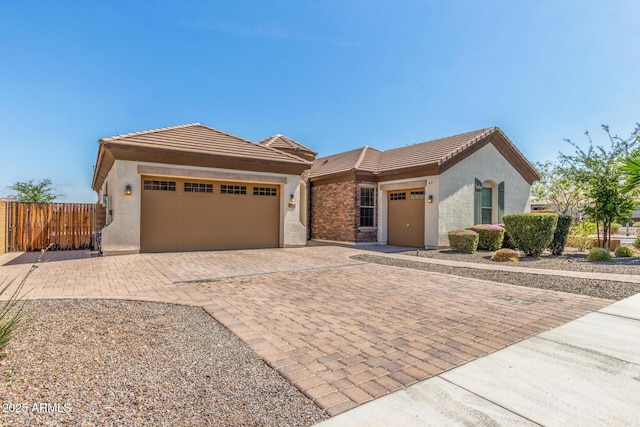 1342 E Milada Dr, Phoenix, AZ 85042 - view of front of property with an attached garage, decorative driveway, stucco siding, and a tile roof