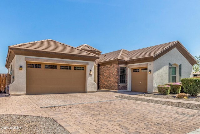 1342 E Milada Dr, Phoenix, AZ 85042 - single story home with a garage, decorative driveway, a tiled roof, and stucco siding