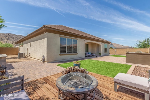 1342 E Milada Dr, Phoenix, AZ 85042 - rear view of property featuring a fire pit, a deck with mountain view, stucco siding, a patio area, and central AC unit