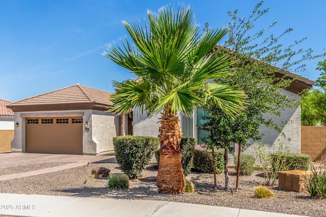 1342 E Milada Dr, Phoenix, AZ 85042 - view of front facade featuring a garage, stucco siding, and concrete driveway