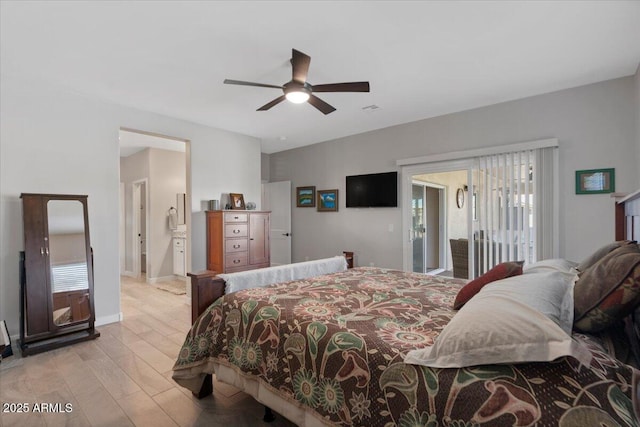 bedroom with baseboards, multiple windows, wood finished floors, and access to outside