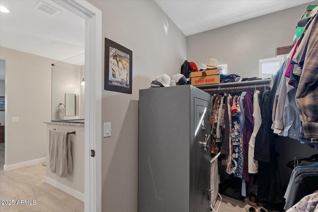 spacious closet featuring visible vents